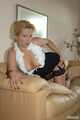 Cute pierced blonde Nina posing in netstockings on couch 8