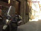016141 Eve Tries To Hide Beside A Parked Motorcycle As She Pees In The Street 6